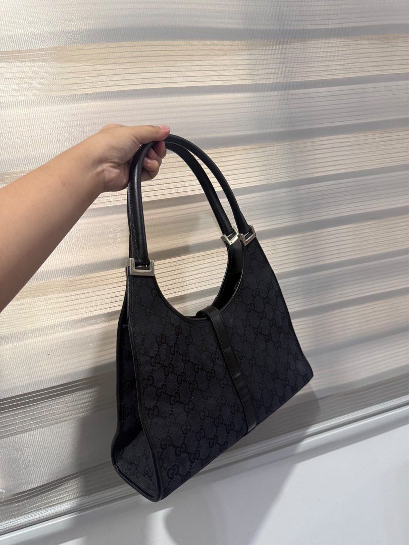 Gucci Jackie Black Monogram Canvas Shoulder Bag (Category: Luxury Bags & Wallets) located in Santiago. Submitted by dobongsoon (Listing ID 1470736239, Image 3). Description: - Brand: Gucci Jackie - Material: Black GG canvas with smooth leather trim - Hardware: Silver-tone piston lock closure - Features: Single shoulder strap, structured base, and clean interior lining - Style: Classic vintage, perfect everyday size for your essentials.