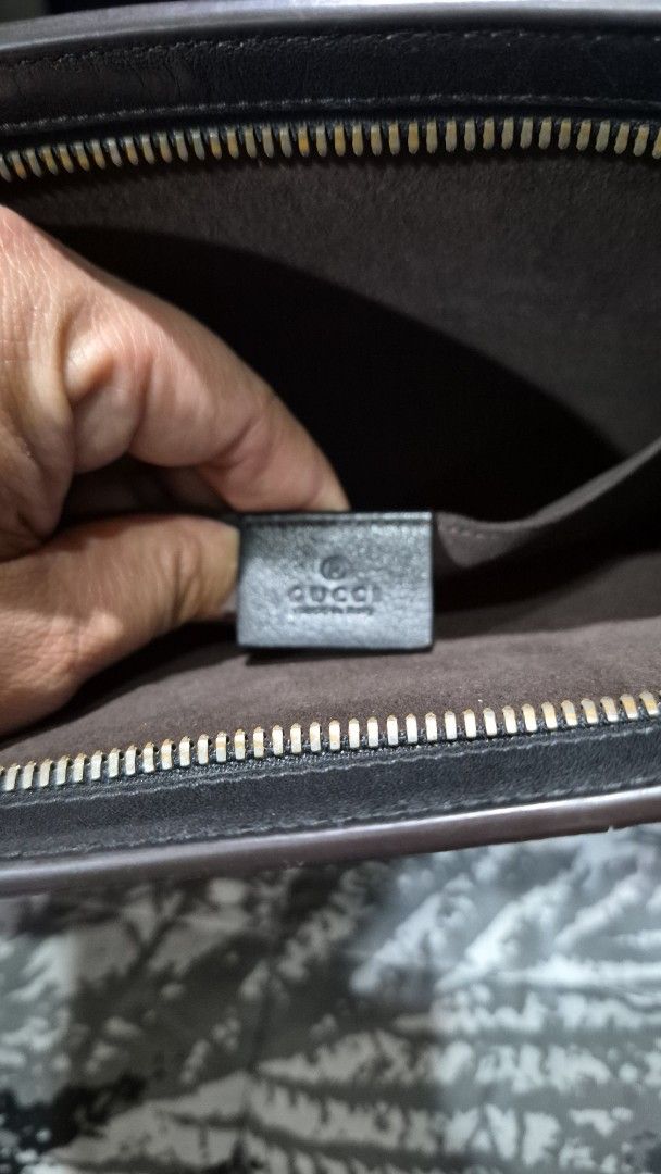 Gucci pouch with zipper closure (Category: Purses & Pouches) located in Baguio. Submitted by jhaz_bags (Listing ID 1470676584, Image 1). Description: - Authentic Gucci pouch with iconic exterior striped webbing - Secure zipper closure with clean dark fabric interior lining - Interior stamped with classic Gucci logo and 'Made in Italy' - Stylish silver-tone metal hardware finish - Compact and versatile for everyday use or special occasions - Guara