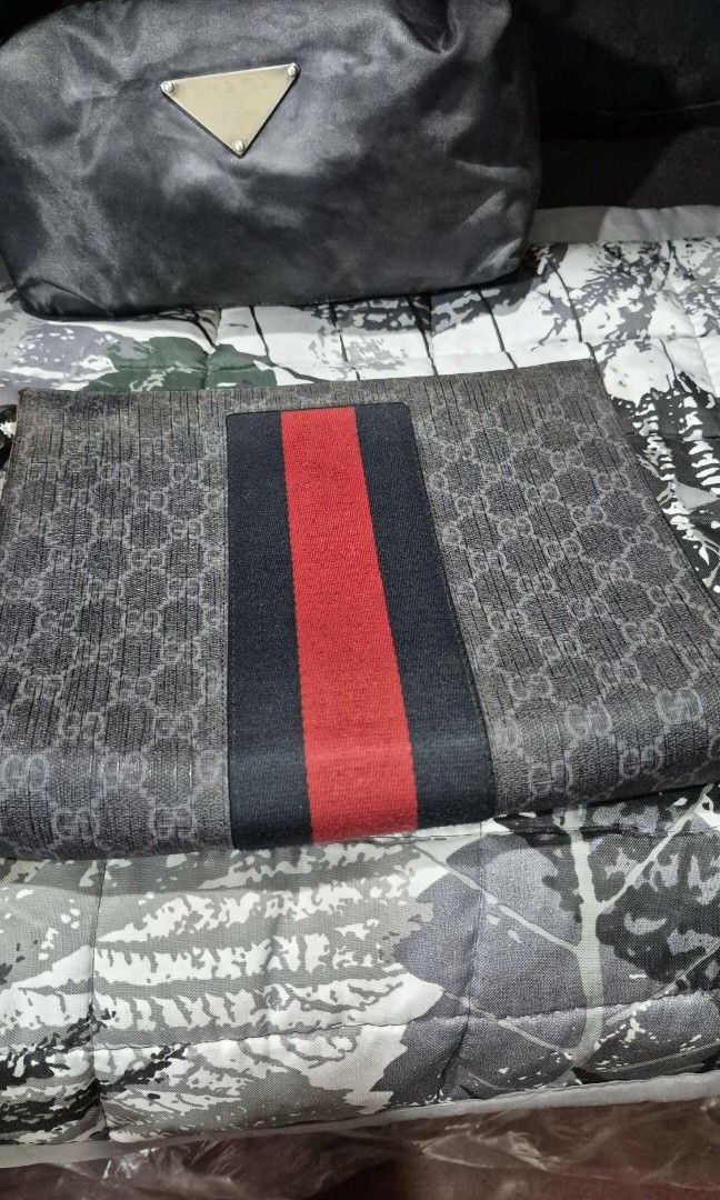 Gucci pouch with zipper closure (Category: Purses & Pouches) located in Baguio. Submitted by jhaz_bags (Listing ID 1470676584, Image 3). Description: - Authentic Gucci pouch with iconic exterior striped webbing - Secure zipper closure with clean dark fabric interior lining - Interior stamped with classic Gucci logo and 'Made in Italy' - Stylish silver-tone metal hardware finish - Compact and versatile for everyday use or special occasions - Guara