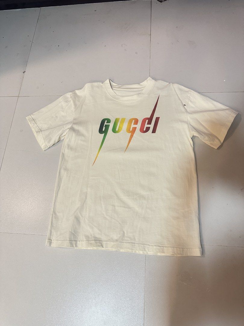 Gucci White & Multicolor Blade Logo T-Shirt (Category: Tshirts & Polo Shirts ) located in Angeles City. Submitted by royal_vintage_thriftshop (Listing ID 1470650166, Image 3). Description: Gucci White & Multicolor Blade Logo T-Shirt No name tag Only washtag Oversize Large Chest 21, Length 28.