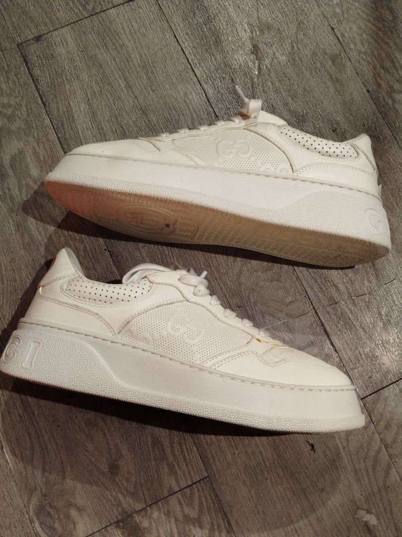 Gucci White Leather Platform Sneakers with Interlocking G (Category: Sneakers) located in Quezon City. Submitted by epoquebyjaz (Listing ID 1470632209, Image 2). Description: - Brand: Gucci - Style: White Leather Platform Sneakers - Details: All-over perforated design with embossed interlocking G monogram - Features: Thick platform sole with Gucci lettering on the heel, gold-printed interlocking G logo at the heel tab, branded tongue tag - Origin