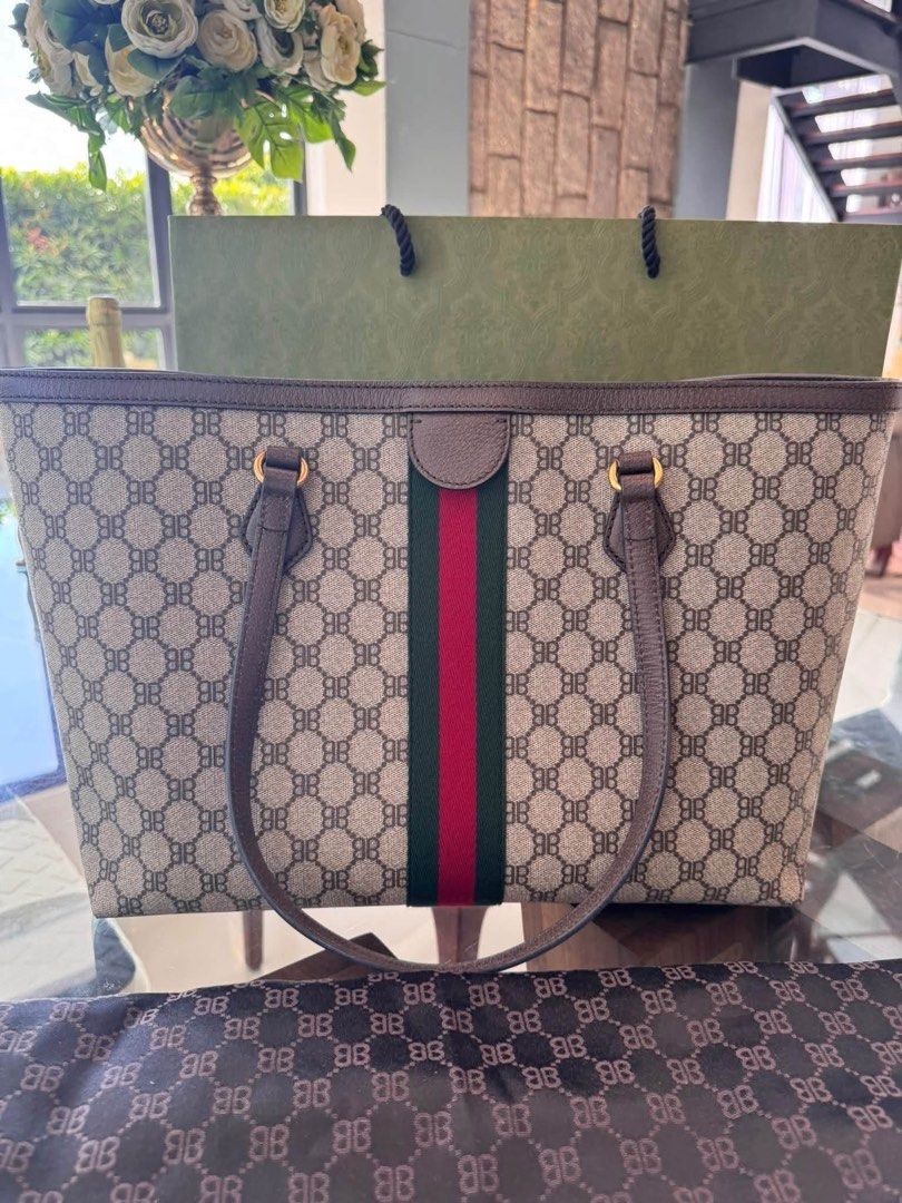 Gucci x Balenciaga Hacker Project Medium Graffiti Tote Bag (Category: Tote Bags) located in Quezon City. Submitted by jingjing93 (Listing ID 1470660289, Image 3). Description: - Authentic UNUSED Gucci x Balenciaga Hacker Project medium graffiti tote - Beige monogram jacquard canvas with BB print and signature green-red-green web stripe - Features bold black spray paint graffiti 'This Is Not A Gucci Bag' across the front - Premium brown leather tr