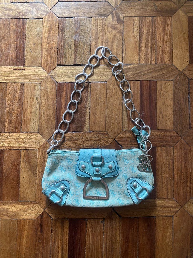 Guess Blue Monogram Shoulder Bag Chain Strap (Category: Shoulder Bags) located in Manila. Submitted by anthony1723 (Listing ID 1470697107, Image 1). Description: - Brand: Guess - Style: Y2K aqua blue monogram shoulder bag - Details: Faux ostrich leather trim, silver hardware, chunky chain strap, and dangling G logo charm - Closure: Magnetic snap flap with main zippered compartment - Interior: One zipper pocket and two slip pockets - Condition: Sh