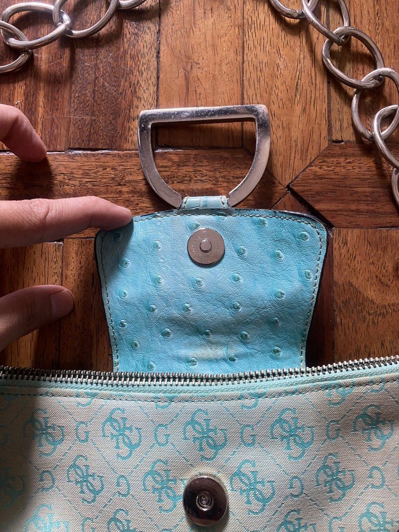 Guess Blue Monogram Shoulder Bag Chain Strap (Category: Shoulder Bags) located in Manila. Submitted by anthony1723 (Listing ID 1470697107, Image 3). Description: - Brand: Guess - Style: Y2K aqua blue monogram shoulder bag - Details: Faux ostrich leather trim, silver hardware, chunky chain strap, and dangling G logo charm - Closure: Magnetic snap flap with main zippered compartment - Interior: One zipper pocket and two slip pockets - Condition: Sh