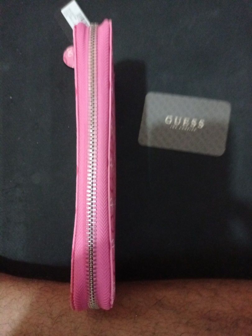 Guess Pink Logo Print Zip-Around Wallet (Category: Wallets & Card holders) located in Manila. Submitted by luckyeagle-7ff8 (Listing ID 1470587909, Image 3). Description: - Brand: Guess - Color: Bright Pink with all-over monogram print - Hardware: Gold-tone with front metal logo plaque - Closure: Secure zip-around design - Interior: Multiple card slots, compartments, and zippered coin pocket - Condition: Brand new with original tags and card inclu