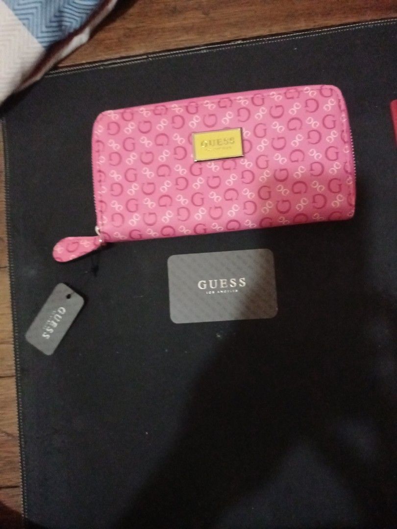 Guess Pink Logo Print Zip-Around Wallet (Category: Wallets & Card holders) located in Manila. Submitted by luckyeagle-7ff8 (Listing ID 1470587909, Image 2). Description: - Brand: Guess - Color: Bright Pink with all-over monogram print - Hardware: Gold-tone with front metal logo plaque - Closure: Secure zip-around design - Interior: Multiple card slots, compartments, and zippered coin pocket - Condition: Brand new with original tags and card inclu
