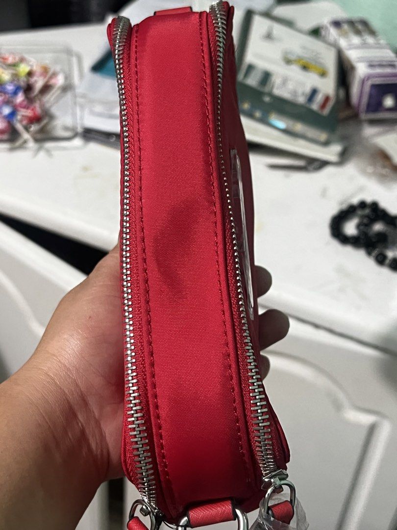 GUESS Red Nylon Pouch Cosmetics Bag (Category: Purses & Pouches) located in Manila. Submitted by cleverstone_21f597 (Listing ID 1470583632, Image 3). Description: - Brand: Guess - Color: Bright red nylon - Condition: Brand new, never used (logo still has protective plastic film) - Hardware: Silver-tone wrap-around zippers with dual pull tabs - Design: Compact rectangular shape - Best for: Storing makeup, small essentials, or daily trinkets.