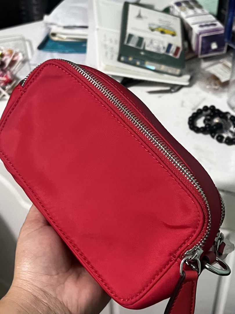 GUESS Red Nylon Pouch Cosmetics Bag (Category: Purses & Pouches) located in Manila. Submitted by cleverstone_21f597 (Listing ID 1470583632, Image 2). Description: - Brand: Guess - Color: Bright red nylon - Condition: Brand new, never used (logo still has protective plastic film) - Hardware: Silver-tone wrap-around zippers with dual pull tabs - Design: Compact rectangular shape - Best for: Storing makeup, small essentials, or daily trinkets.