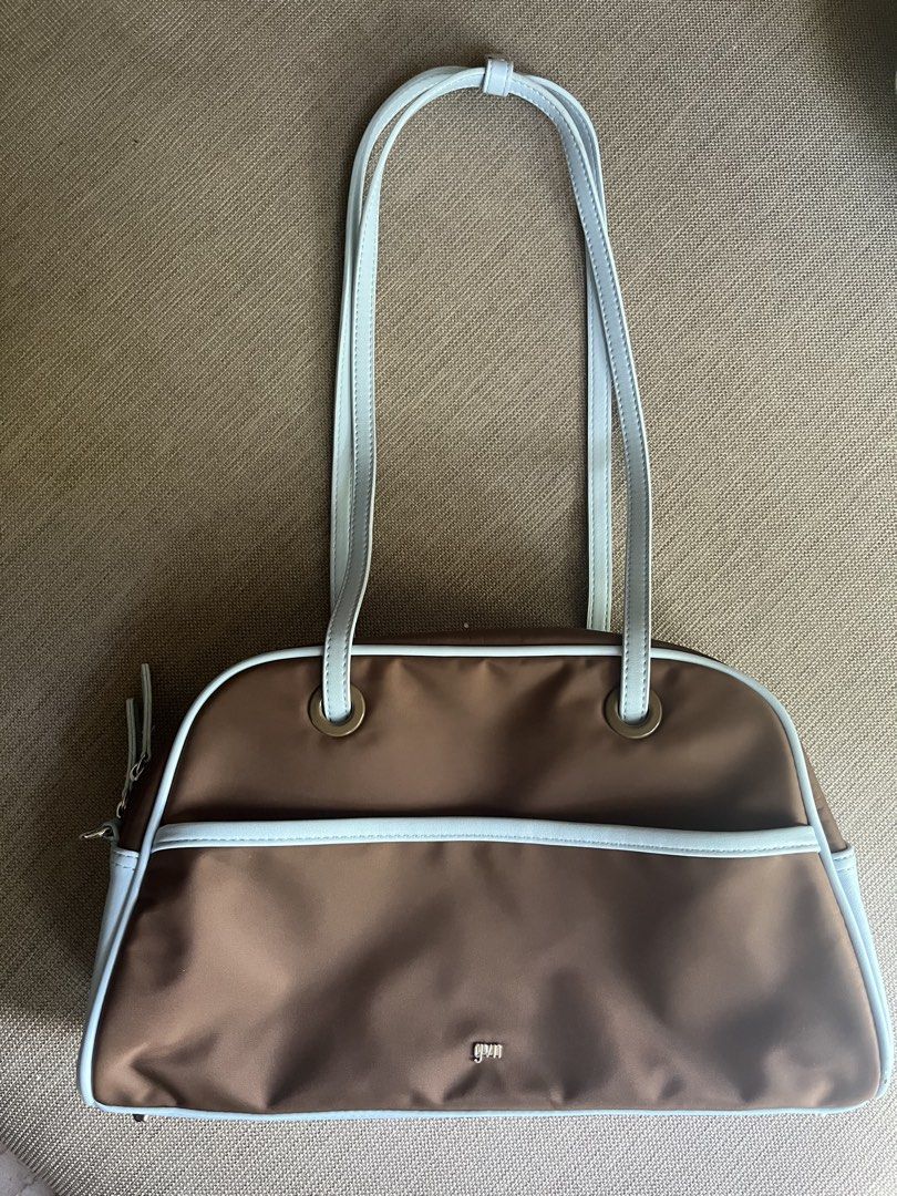 GVN Medium Nylon Bowler Bag in Slate (Category: Shoulder Bags) located in Paranaque City. Submitted by lulusclosetfinds (Listing ID 1470610985, Image 1). Description: wts lfb ph only used a few (3-5) times for a trip :) tag is removed but can include it for authenticity purposes~ in great condition (9.5/10) no dust bag included - Brand: GVN - Style: Medium nylon bowler shoulder bag - Color: Slate (Brown body with light blue straps and piping) - H