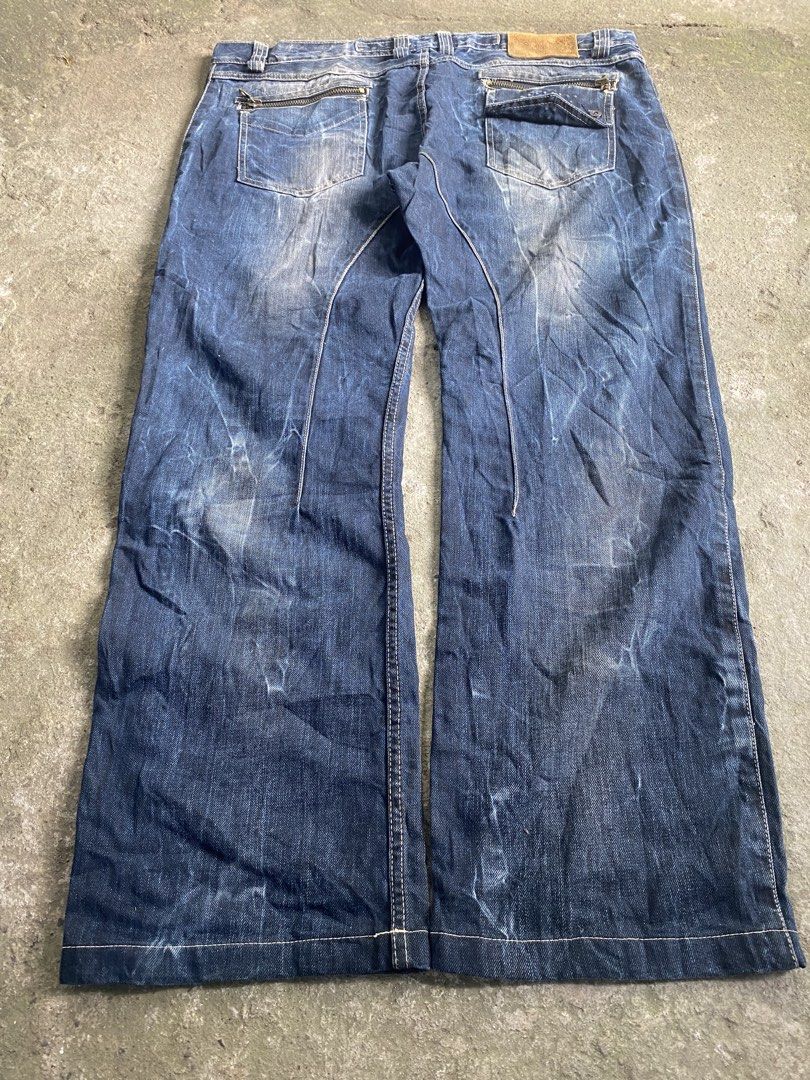 Hacker Jeans Dark Blue Distressed Denim Zip Pocket (Category: Jeans) located in Caloocan City. Submitted by remythrift (Listing ID 1470589986, Image 2). Description: - Color: Dark blue with heavy pre-wash fading and distressing - Pockets: Distinctive zipper pocket on front left thigh and zipped back pockets - Fit & Style: Straight leg cut, structured multi-panel leg stitching, and raw hems - Details: Classic button closure with intact belt loops 