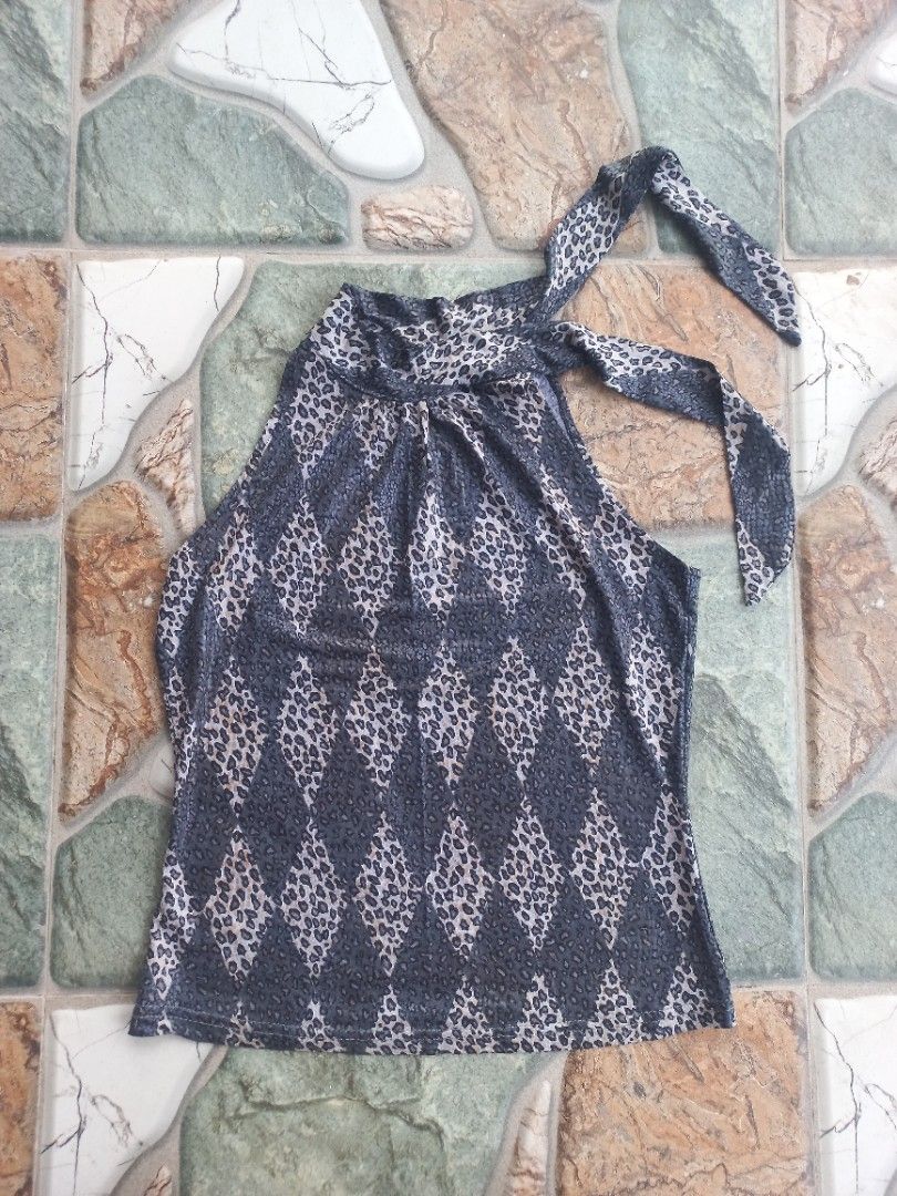 Halter neck leopard print sleeveless top (Category: Sleeveless) located in Davao. Submitted by bloodyriz (Listing ID 1470647267, Image 1). Description: - Color: Grey and black - Design: All-over leopard print - Style: Sleeveless, fitted, halter neck with tie straps - Fabric: Lightweight and comfortable - Versatile: Easy to pair with jeans or skirts for a casual day out.