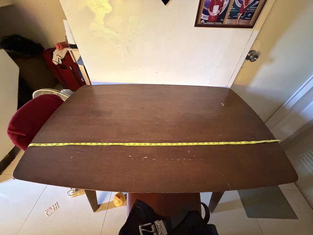 Hardwood Dining Table (Category: Coffee & Tea Tableware) located in Las Pinas. Submitted by bibliomomma (Listing ID 1470591969, Image 2). Description: Hardwood dining table with a classic brown finish. Sturdy legs and spacious tabletop, perfect for everyday dining or family use. Preloved with visible scratches and signs of wear. Still functional and ready for a new home. RFS: too big for our small apartment Length 48 inches Height 27 inches MOP G