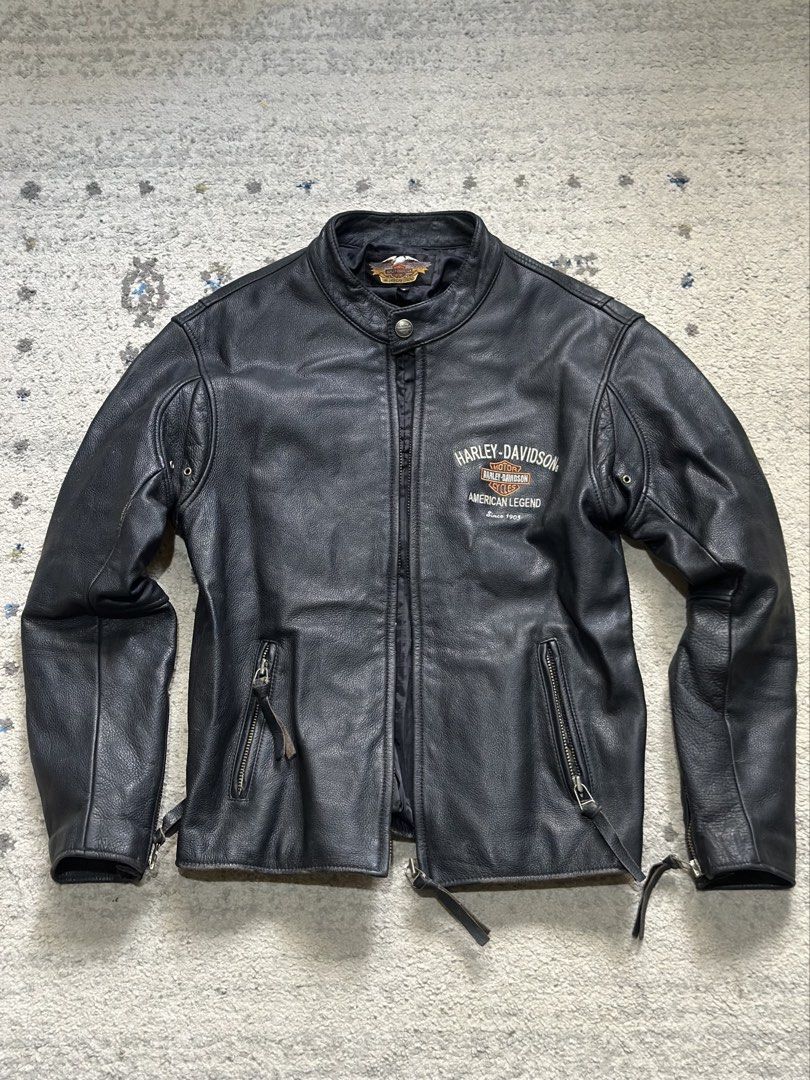 Harley-Davidson American Legend Leather Jacket (Category: Coats, Jackets and Outerwear) located in Daet. Submitted by thrifthings2018 (Listing ID 1470629131, Image 2). Description: - Authentic black Harley-Davidson leather jacket - Heavyweight genuine leather with warm quilted lining - Large embroidered American Legend and Bar & Shield back graphic - Smaller embroidered logo on the left chest - Functional features: zip pockets, zippered cuffs, sn