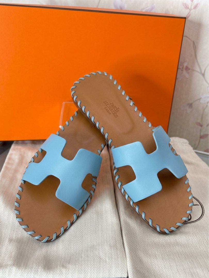 Hermes Oran Braided (Category: Sneakers & Footwear) located in Mandaluyong City. Submitted by AvekLuxuriesPh2020 (Listing ID 1470583436, Image 3). Description: This is a pair of Hermès Oran Braided Sandals in a light pastel blue leather colorway (often referred to by the brand as Vert D’eau or Bleu Galet This particular variation is a limited or special edition of the classic Hermès Oran slide, featuring a distinct whipstitch braided detail along