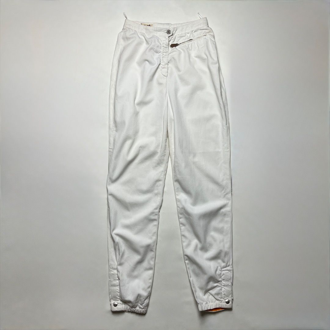 Hermès Paris White Pants Size 36 (Category: Jeans) located in Caloocan City. Submitted by achilles_grails (Listing ID 1470565798, Image 1). Description: - Brand: Hermès Paris - Size: 36 (Tag attached) - Color: White with signature orange trim - Material: Premium cotton blend (Specialist dry clean only) - Fit: High-waist with elastic waistband and zip closure - Details: Adjustable inner ankle cuffs with secure velcro straps and branded Hermès silv