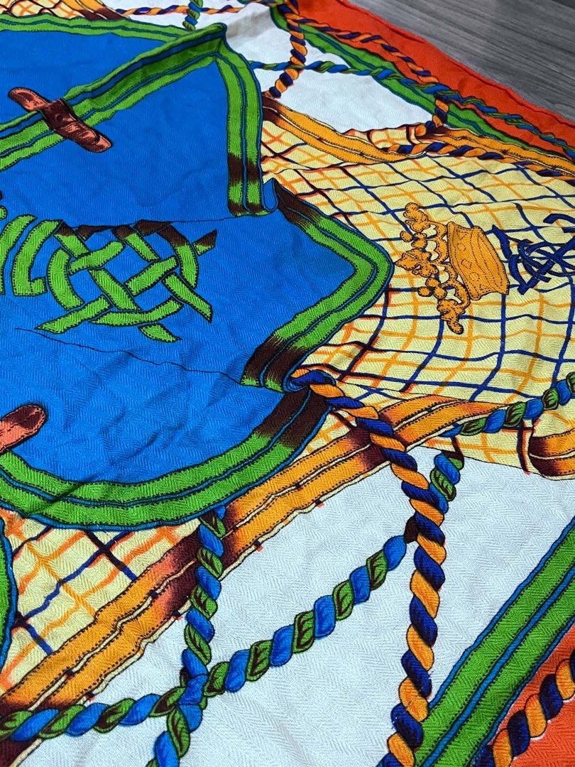 Hermès Silk Scarf Orange Blue Equestrian Design (Category: Scarves) located in Dagupan City. Submitted by fahionista1988 (Listing ID 1470707873, Image 3). Description: - Hermès silk scarf - Vibrant colorway in orange, blue, green, and white - Intricate equestrian theme with ropes, buckles, shields, crowns, and heraldic lions - Approximate dimensions: 46 x 47 inches - Signature hand-rolled edges - Hermès fabric label attached and visible in photos