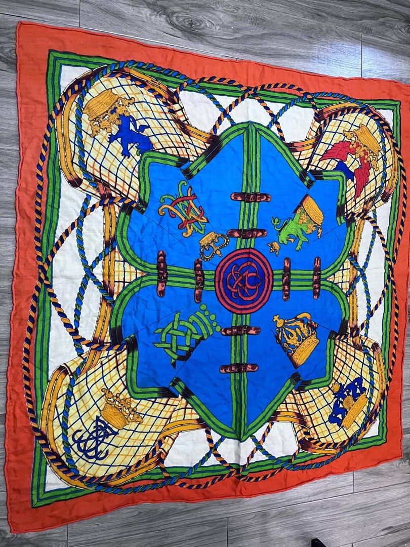 Hermès Silk Scarf Orange Blue Equestrian Design (Category: Scarves) located in Dagupan City. Submitted by fahionista1988 (Listing ID 1470707873, Image 1). Description: - Hermès silk scarf - Vibrant colorway in orange, blue, green, and white - Intricate equestrian theme with ropes, buckles, shields, crowns, and heraldic lions - Approximate dimensions: 46 x 47 inches - Signature hand-rolled edges - Hermès fabric label attached and visible in photos