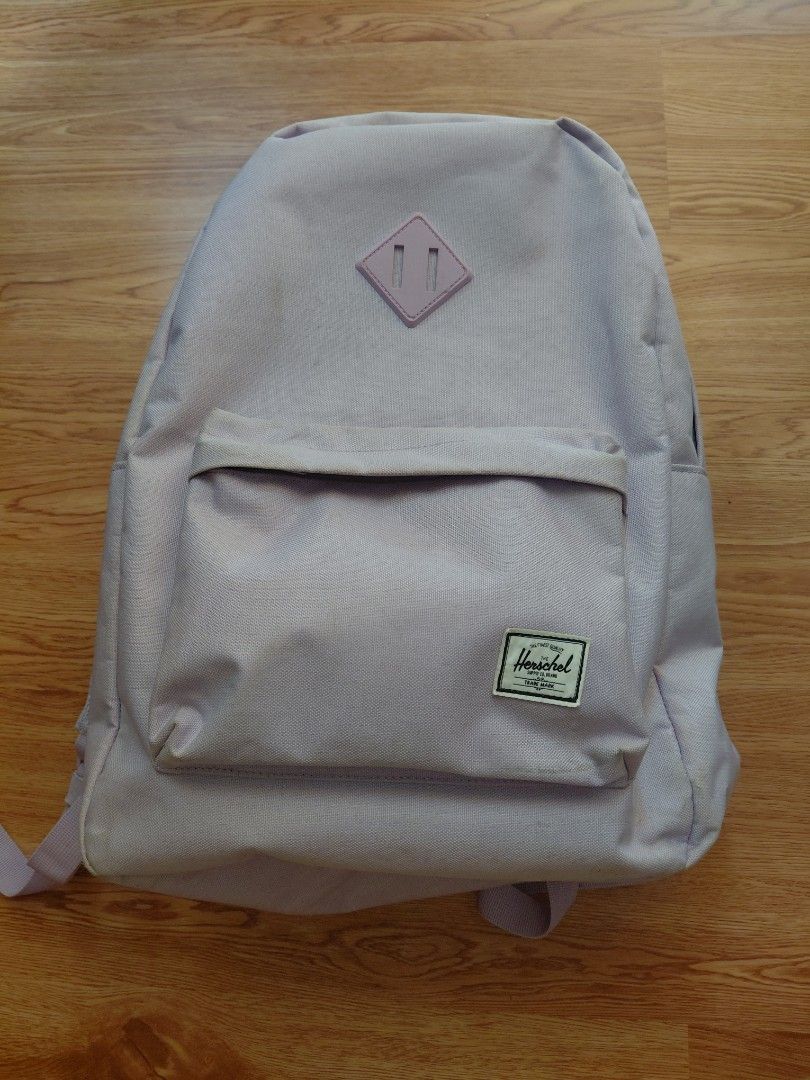 Herschel Supply Co. Light Purple Backpack (Category: Backpacks) located in Quezon City. Submitted by prelovedbythea19 (Listing ID 1470633083, Image 1). Description: - Brand: Herschel Supply Co. -24L - Color: Light purple with signature red and white striped interior lining - Features: Front zippered pocket and classic diamond patch detail - Comfort: Padded and adjustable shoulder straps - Storage: Clean interior with a convenient inner sleeve com