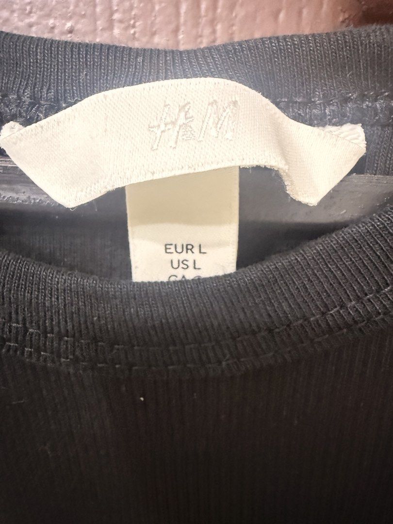 H&M Black Ribbed T-Shirt (Category: Shirts) located in Pasay City. Submitted by annythingz28 (Listing ID 1470666410, Image 2). Description: - Brand: H&M - Item: Black ribbed t-shirt - Size: Large - Fit: Standard fit with short sleeves and round neckline - Material: Stretchy cotton blend - Condition: Great basic piece for layering or standalone wear.