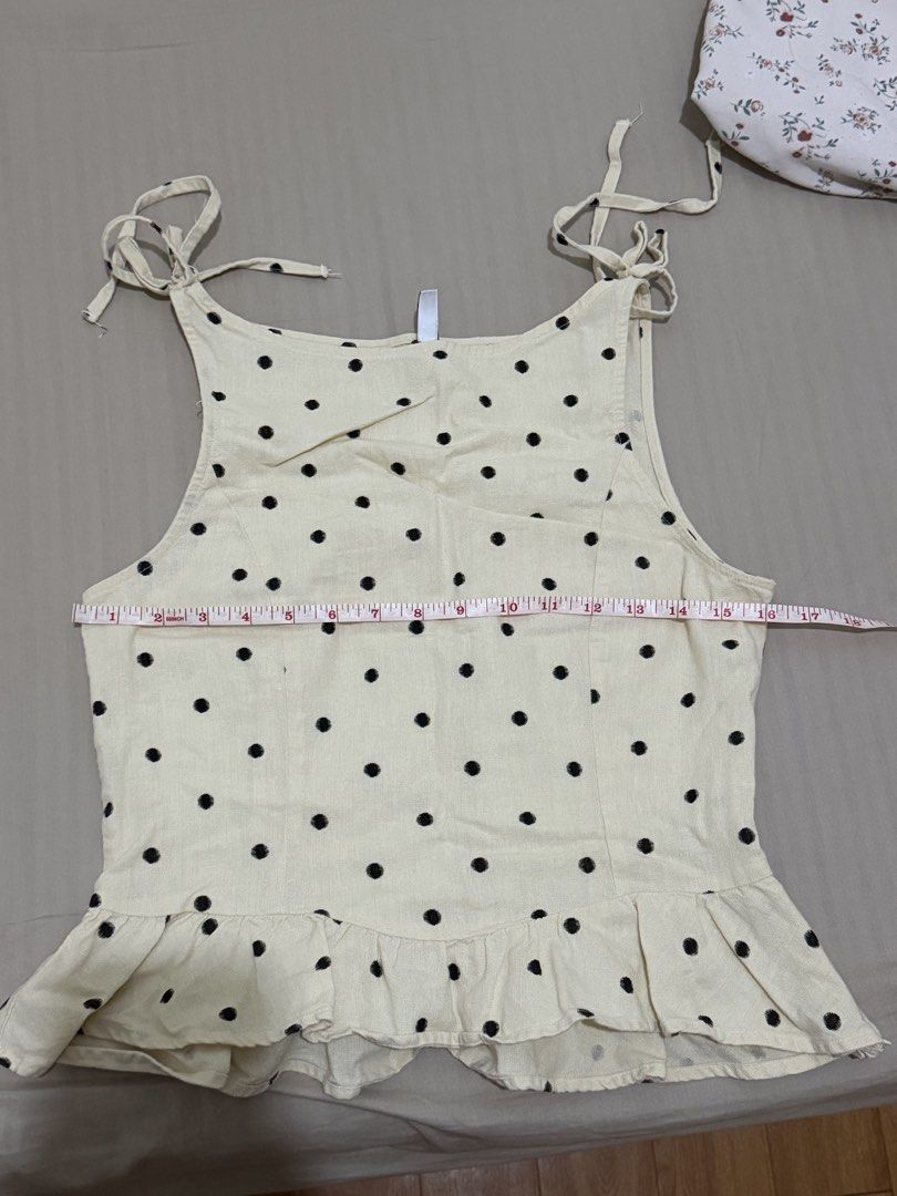 H&M Divided Polka Dot Peplum Top Size S (Category: Sleeveless) located in Manila. Submitted by jane_marga (Listing ID 1470681925, Image 3). Description: - Brand/Model: H&M Divided Cami Top - Color/Pattern: Cream with all-over black polka dots - Size: S (EUR S, US S, CN 165/88A) - Measurements: Pit-to-pit ~17 inches, Length ~18.5 inches - Details: Tie-shoulder straps, peplum hem - Material: Light and breezy, perfect for casual wear - Condition: Ex