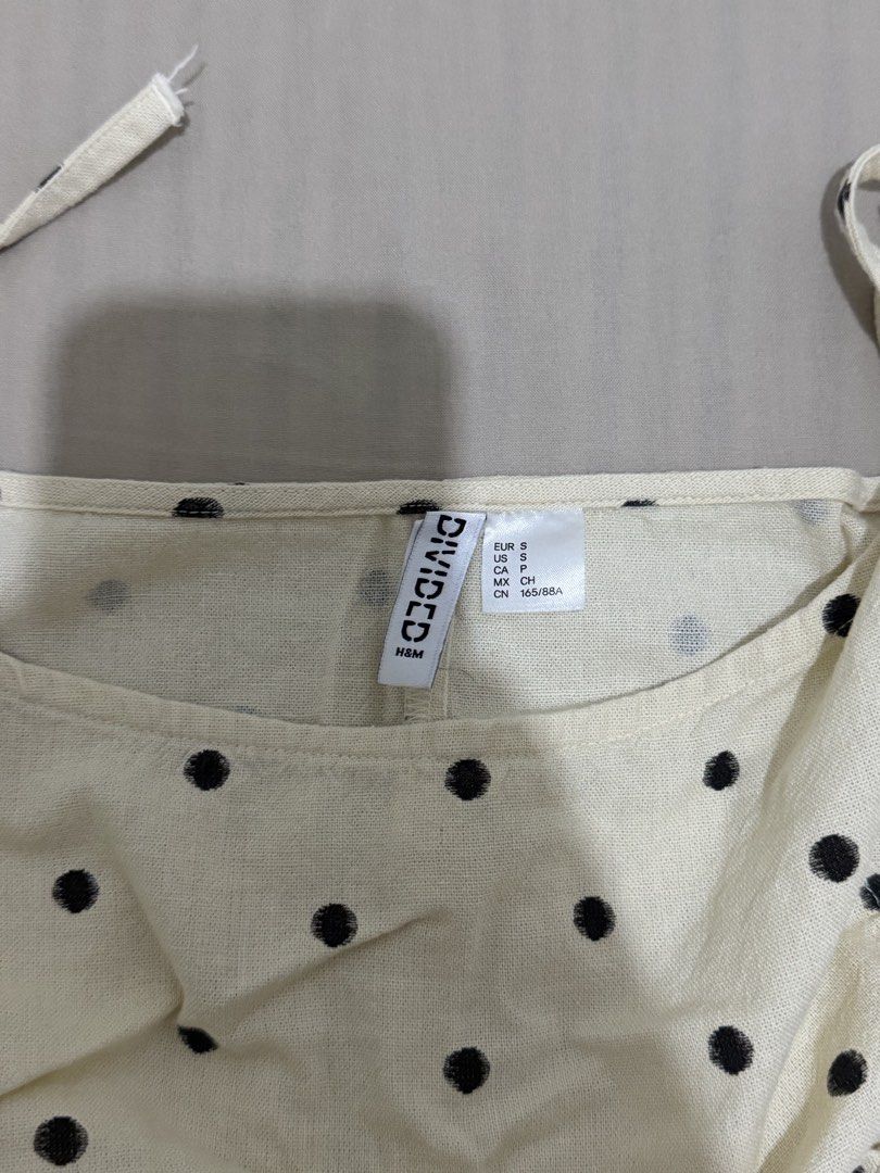 H&M Divided Polka Dot Peplum Top Size S (Category: Sleeveless) located in Manila. Submitted by jane_marga (Listing ID 1470681925, Image 2). Description: - Brand/Model: H&M Divided Cami Top - Color/Pattern: Cream with all-over black polka dots - Size: S (EUR S, US S, CN 165/88A) - Measurements: Pit-to-pit ~17 inches, Length ~18.5 inches - Details: Tie-shoulder straps, peplum hem - Material: Light and breezy, perfect for casual wear - Condition: Ex