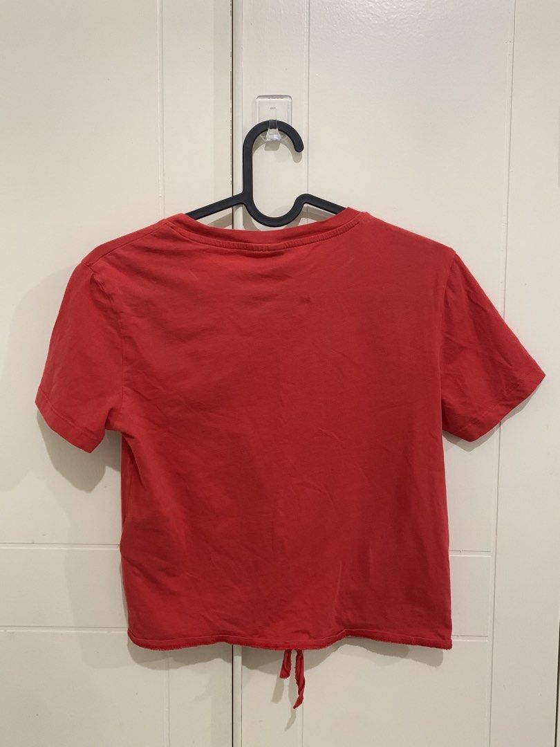 H&M Divided Red Crop Top Tee Size XS (Category: Shirts) located in Pasig City. Submitted by lovedbyri (Listing ID 1470688142, Image 2). Description: - Brand/Style: H&M Divided Red Crop Top - Size: EUR/UK XS (CN 160/80A) - Material: 100% comfortable cotton - Details: Short sleeves, round neckline, trendy tie-knot hem - Condition: Clean, excellent basic tee for casual outfits - Styling: Perfect match with high-waisted jeans or shorts.