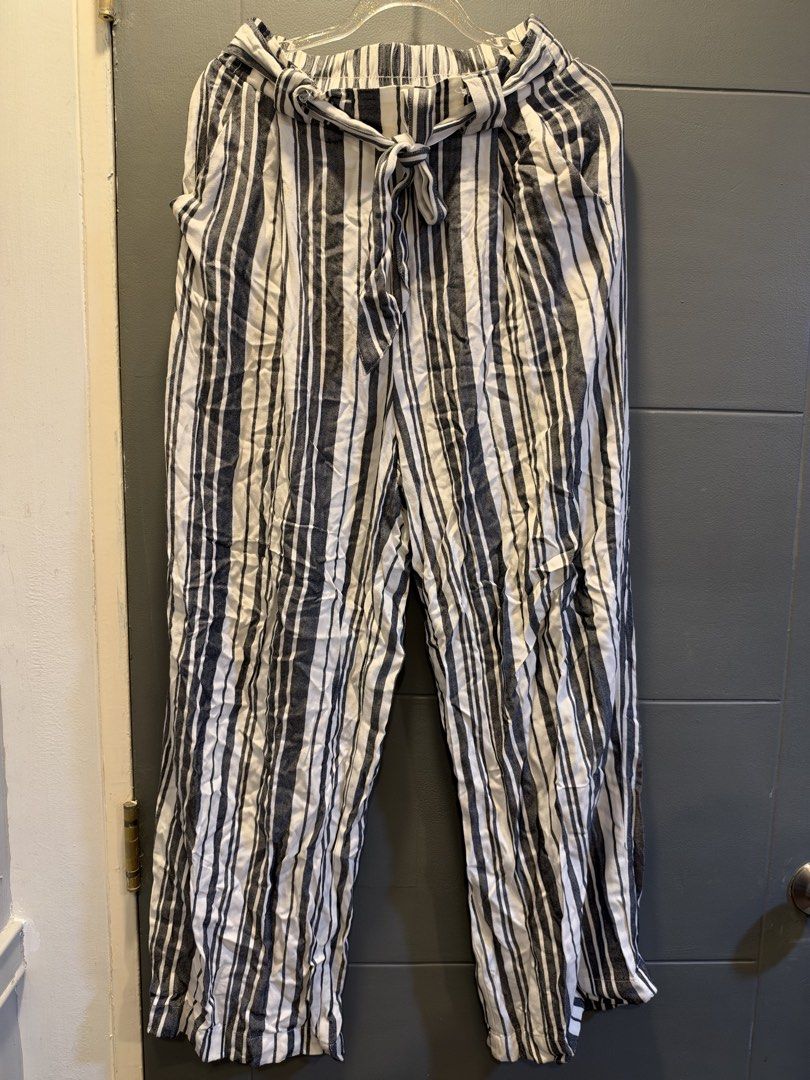 H&M Divided Striped Tie-Waist Pants (Category: Other Bottoms) located in Manila. Submitted by anjcuenca (Listing ID 1470696573, Image 1). Description: - Brand: H&M Divided - Pattern: Black and white vertical stripes - Size: EUR 36P / US 4P / CA 4P - Waistband: Elastic with a matching fabric tie belt - Material: Lightweight and comfortable - Origin: Made in India - Style: Versatile for casual wear or slight dress-up.