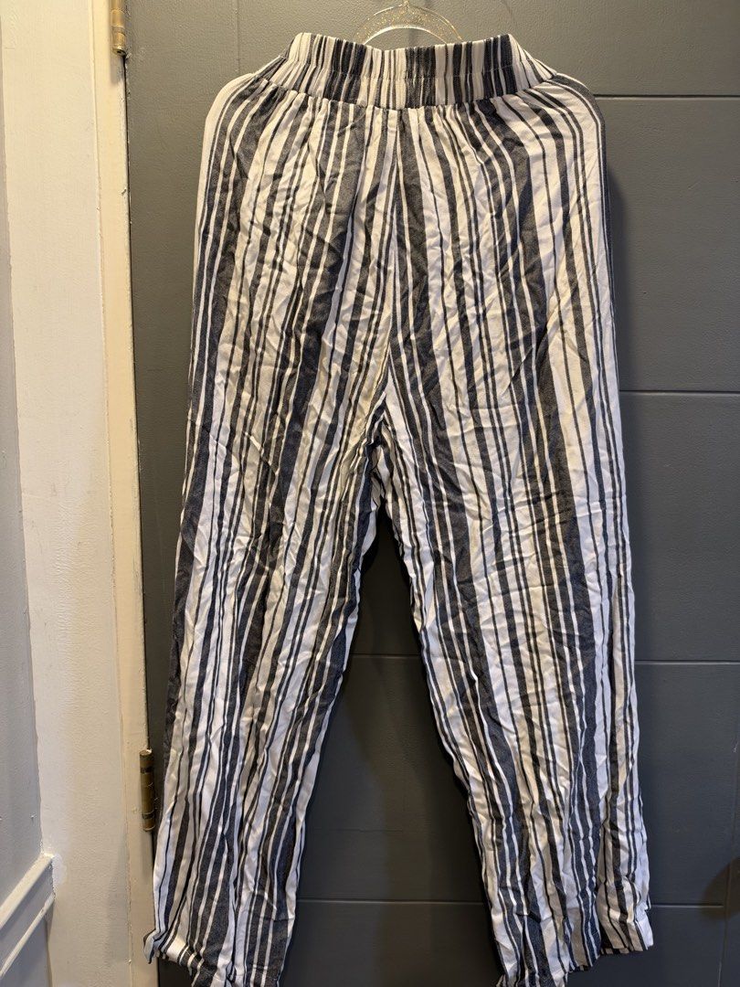 H&M Divided Striped Tie-Waist Pants (Category: Other Bottoms) located in Manila. Submitted by anjcuenca (Listing ID 1470696573, Image 2). Description: - Brand: H&M Divided - Pattern: Black and white vertical stripes - Size: EUR 36P / US 4P / CA 4P - Waistband: Elastic with a matching fabric tie belt - Material: Lightweight and comfortable - Origin: Made in India - Style: Versatile for casual wear or slight dress-up.