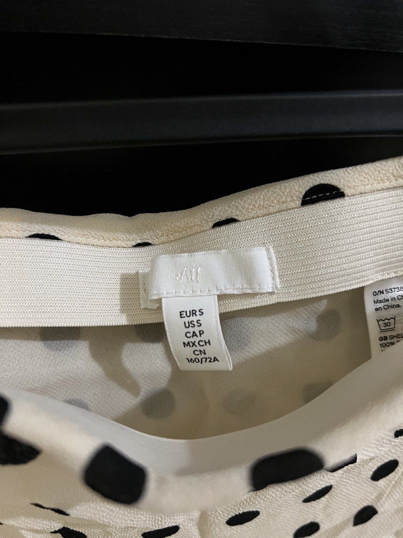 H&M Polka Dot Midi Skirt (Category: Skirts) located in Quezon City. Submitted by eicadh (Listing ID 1470662098, Image 3). Description: - Brand: H&M - Size: S (fits true to size) - Color/Pattern: Cream with black polka dots - Material: Lightweight fabric - Features: Flared silhouette, comfortable elastic waistband - Condition: Excellent - Perfect for: Casual days out, weekend brunches.