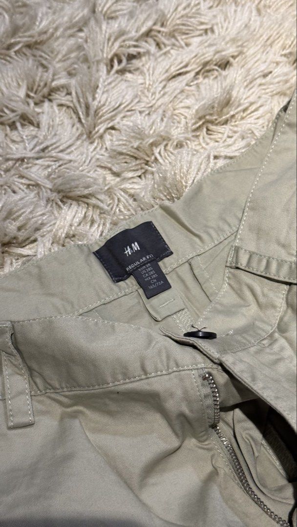 H&M Regular Fit Olive Green Shorts Size 28 (Category: Shorts) located in Manila. Submitted by kyle.daniel (Listing ID 1470650981, Image 2). Description: - Brand: H&M - Style: Regular fit casual shorts - Color: Khaki beige - Size: US 28 / EUR 28 - Closure: Standard button with zipped fly - Pockets: 2 front slip pockets, 2 buttoned back pockets - Condition: Excellent, clean with no stains or damage.