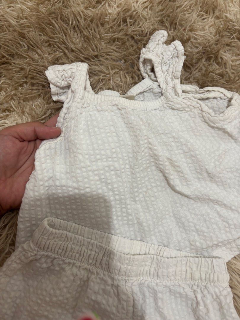 H&M White Ruffle Top and Shorts Set (Category: Sets or Coordinates) located in Bulacan. Submitted by ricammendz (Listing ID 1470730858, Image 3). Description: - Brand: H&M - Set: Matching top and shorts in crisp white - Material: Textured fabric - Top Details: Cute ruffle straps, relaxed fit - Shorts Details: Comfortable elastic waistband - Size: 6-8 months (EU 74) but can fit till 24m - Condition: Clean and ready for your little one - Perfect fo