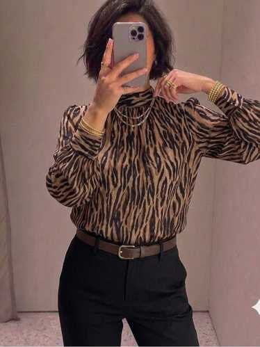 H&M Zebra Print High-Neck Longsleeves (Category: Blouses) located in Quezon City. Submitted by dropdeadprices (Listing ID 1470630872, Image 3). Description: - Brand: H&M New and unused and still in the hm website; only removed tags - Print: Brown and black zebra print - Size: EUR S / US S - Details: High neckline with back button closure, long sleeves with buttoned cuffs 21 inches pit to pit when laid flat x 25 inches length.