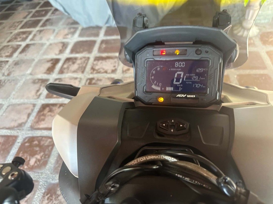Honda ADV 160 Scooter with Upgrades (Category: Motorbikes for Sale) located in Taguig. Submitted by wisedeer.e43cf3 (Listing ID 1470653571, Image 1). Description: Honda ADV 160 scooter in white. Fitted with custom aftermarket upgrades including RCB brake calipers, upgraded disc rotors, titanium bolts, custom seat, and rear rack. Digital odometer reads 1,704 km. Clean condition, well maintained, ready for the road..