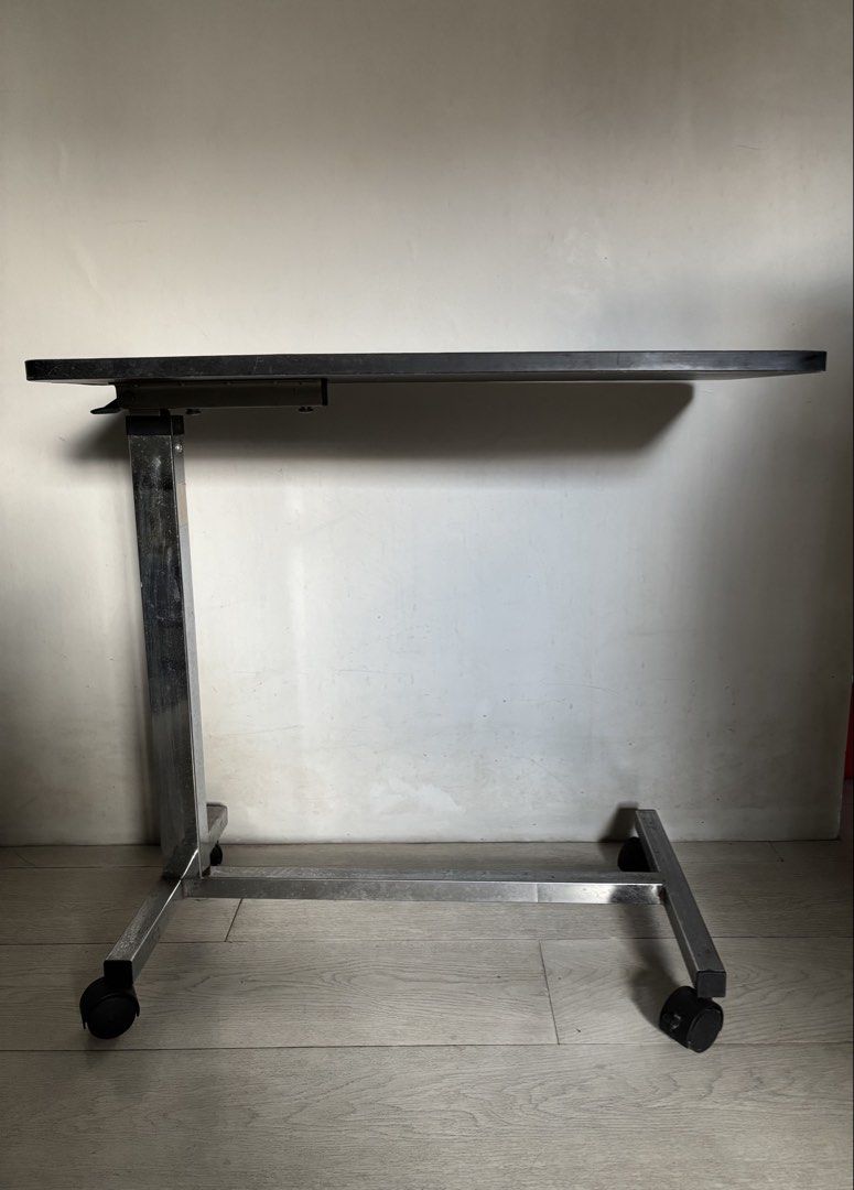 Hospital Bed Table (Category: Tables & Sets) located in Quezon City. Submitted by fruitteapearls (Listing ID 1470582006, Image 2). Description: - Dark wood table top with a smooth finish and subtle wood grain - Rectangular shape with modern rounded corners - Heavy, solid, and durable construction - Compatible with standard table bases - Adjustable height.