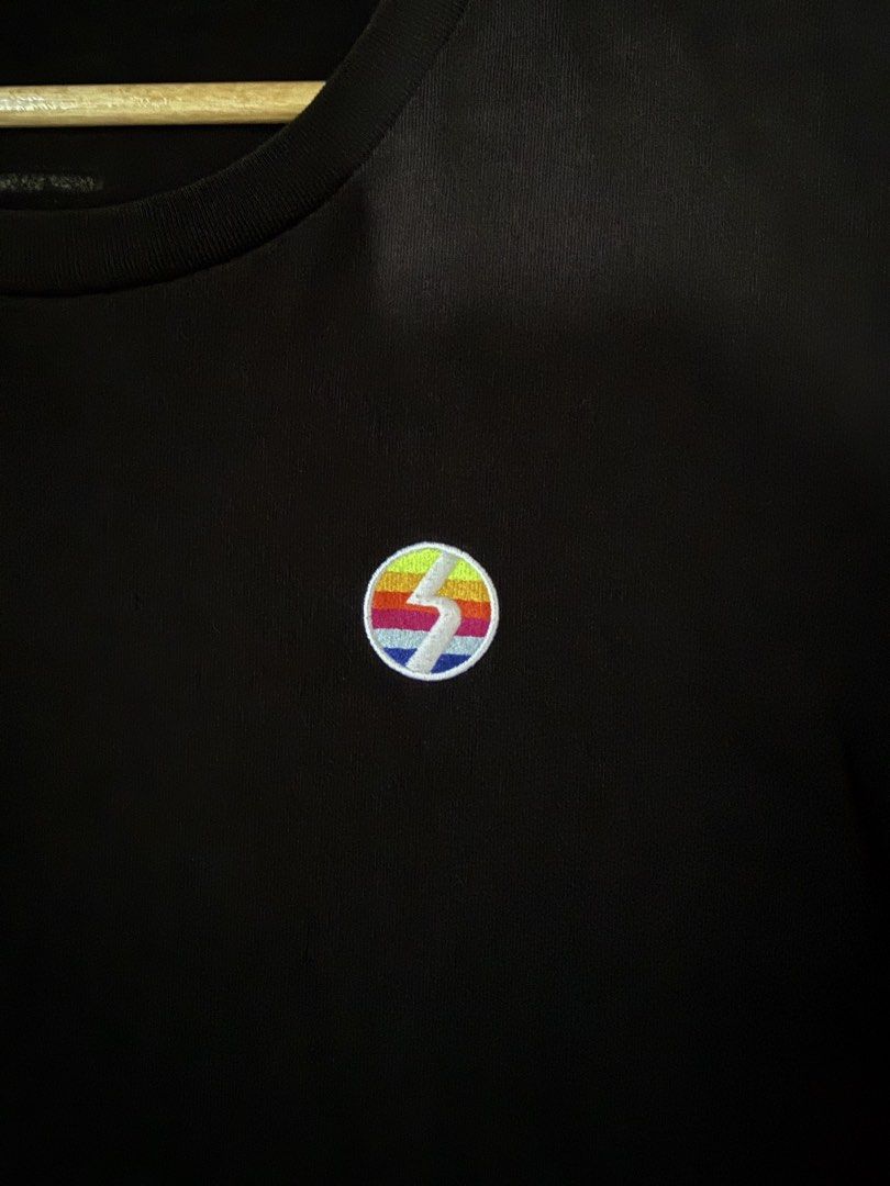 Hotkey Rate One Graphic Tee Black Size M (Category: Tshirts & Polo Shirts ) located in Manila. Submitted by keepercollection (Listing ID 1470588147, Image 3). Description: - Brand: Hot Key - Color: Black - Size: Small (Measures approx. 21 inches across the chest) - Design: Small embroidered circular rainbow patch on the left chest - Back Details: Large colorful graphic with 'Rate One' and 'One Degree Beyond' typography - Condition: Great pre-love