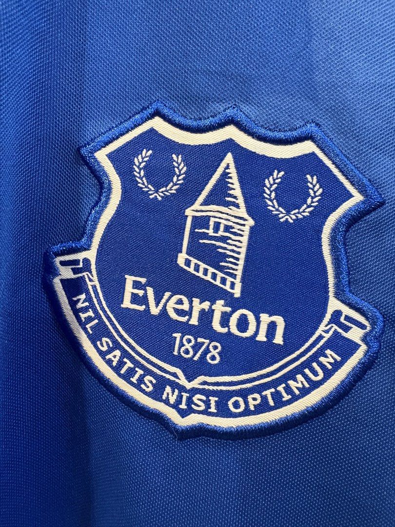 Hummel Everton Home Jersey (Category: Tshirts & Polo Shirts ) located in Echague. Submitted by jake_rc (Listing ID 1470626366, Image 3). Description: Hummel Everton Home Jersey from the 2023–2024 Premier League season, featuring the blue base, white-and-blue patterned polo collar, Hummel chevrons on the shoulders, and the Stake.com sponsor logo. Size US Large Dimes 21 x 28.5 Issue: washable dot stains / 2ndot like lints Price 950 plus SF.