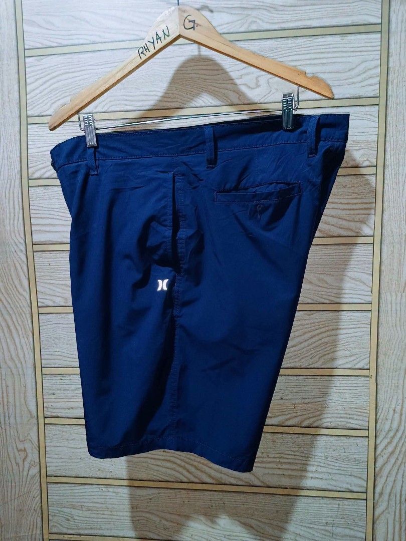 Hurley Men Navy Blue Shorts (Category: Shorts) located in Narra. Submitted by rhyanguan63087 (Listing ID 1470571279, Image 3). Description: - Brand: Hurley Size 36 - Color: Navy blue - Style: Classic fit with belt loops and button closure - Features: Small reflective logo on the leg, back pocket with button flap - Condition/Fabric: Clean fabric - Best for: Casual wear or outdoor activities.