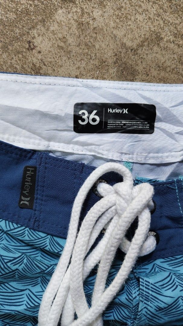 Hurley Phantom Blue Wave Print Boardshorts Size 36 (Category: Swim Trunks & Board Shorts) located in Quezon City. Submitted by truedeer_cda94c (Listing ID 1470605158, Image 3). Description: - Brand: Hurley - Color: Blue with all-over wave pattern - Size: 36 waist - Length: 21 inches - Closure: Front drawstring - Pockets: Back pocket with velcro flap and brand patch - Details: Round Hurley logo patch on left leg and clean interior tags - Condition