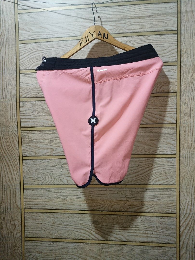 Hurley Phantom Boardshorts Pink Teal (Category: Swim Trunks & Board Shorts) located in Narra. Submitted by rhyanguan63087 (Listing ID 1470571536, Image 2). Description: - 30-31 Waistline Brand: Hurley Phantom - Color: Pink with teal horizontal stripes - Features: Black waistband with adjustable drawstring, secure back zip pocket with Hurley logo, and iconic logo on the left leg - Material: Lightweight, high-performance stretch fabric - Ideal for: