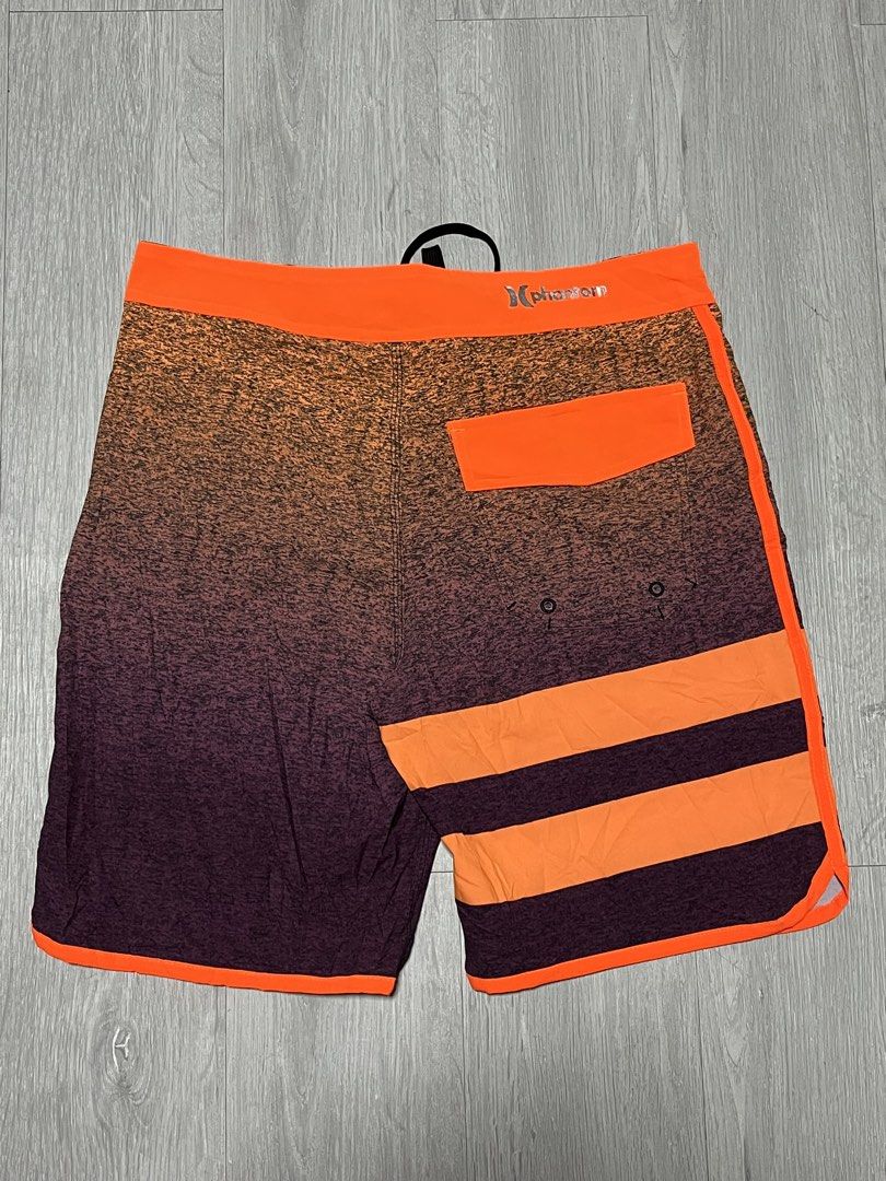 Hurley Phantom Orange Gradient Boardshorts Swim Trunks (Category: Swim Trunks & Board Shorts) located in Manila. Submitted by jorgemabelin2001 (Listing ID 1470697912, Image 2). Description: - Brand: Hurley Phantom - Design: Cool orange to dark purple gradient heather effect - Details: Bright orange waistband, side piping, and back pocket flap - Closure: Black lace-up drawstring with metal grommets - Pocket: Single back pocket with flap and button