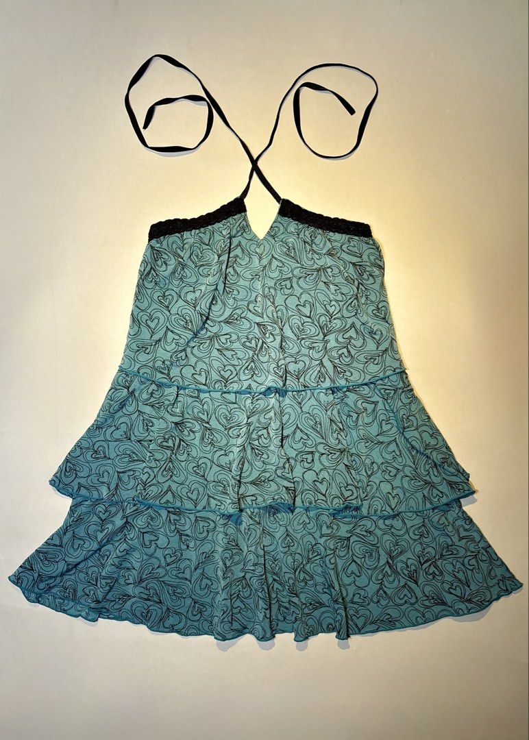 IENA Blue Heart Pattern Halter Neck Tiered Top Size S (Category: Sleeveless) located in Bacolod City. Submitted by thlnn_vls (Listing ID 1470702868, Image 1). Description: - Brand: IENA - Size: Small - Color/Design: Light blue with all-over black heart print - Details: Tiered ruffled design, black lace trim, and thin halter straps - Fit: Lightweight and flowy - Style: Cute Y2K aesthetic.