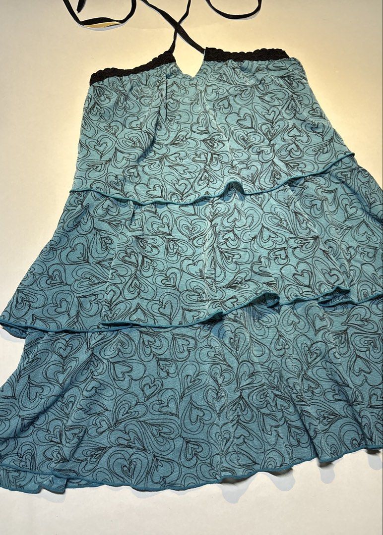 IENA Blue Heart Pattern Halter Neck Tiered Top Size S (Category: Sleeveless) located in Bacolod City. Submitted by thlnn_vls (Listing ID 1470702868, Image 2). Description: - Brand: IENA - Size: Small - Color/Design: Light blue with all-over black heart print - Details: Tiered ruffled design, black lace trim, and thin halter straps - Fit: Lightweight and flowy - Style: Cute Y2K aesthetic.