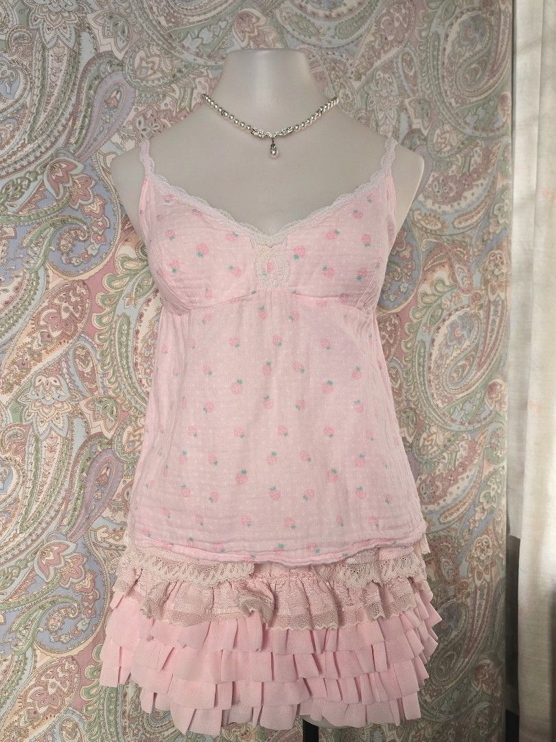 Imi's Pink Strawberry Pattern Cami Top (Category: Sleeveless) located in Dagupan City. Submitted by chislocker14 (Listing ID 1470598139, Image 1). Description: - Design: Pink cami top with all-over strawberry pattern - Details: Delicate lace trim on sweetheart neckline with center bow - Straps: Adjustable spaghetti straps - Material: Soft and breathable cotton gauze fabric - Size: Labeled 160/84A, fits S to M - Brand: Imi's new secret.