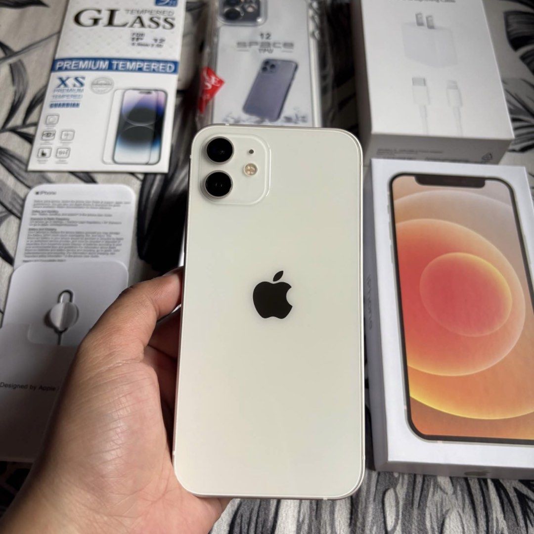 IPHONE 12 128 GB WHITE (Category: iPhone 12 Series) located in Bauang. Submitted by vantro_gadgets (Listing ID 1470559753, Image 2). Description: 🔥 iPhone 12 | 128GB 📱 💰 PRICE: ₱18,500 — FIXED ❌ No Lowballers, Please! ✅ Factory Unlocked | Any SIM 🔋 100% Battery Health* ✅ Face ID & True Tone Working* 📊 3uTools Report Available 📦 Box & Charger Included 🎁 Free Case & Tempered Glass 🤝 Reseller: Ashley Savilla 💬 Message me to order! Features 