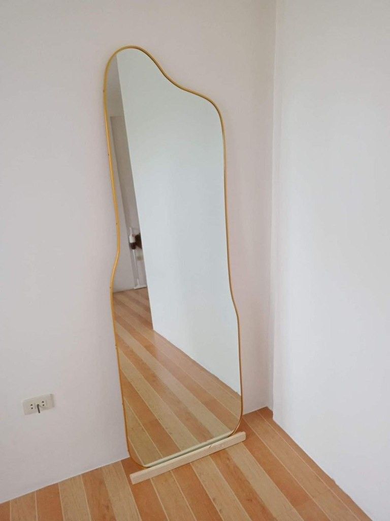Irregular Wave Full Length Mirror (Category: Mirrors) located in Manila. Submitted by zeruve_mirrors (Listing ID 1470599959, Image 3). Description: - Trendy wave-shaped design adds a modern touch to any space (customizable) - Slim golden frame for an elegant look - Comes with a sturdy wooden base block for upright standing - Provides clear glass reflection - Versatile piece, great for bedrooms, hallways, or corners - Can be Customized!.