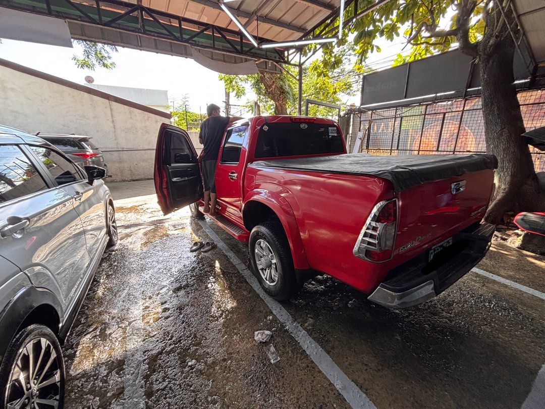 Isuzu D-Max (Category: Used Cars) located in Quezon City. Submitted by mr.kalmado (Listing ID 1470690448, Image 3). Description: 🚘 FOR SALE: 2010 ISUZU D-MAX 3.0 DIESEL A/T | 4x2 DOUBLE CAB 💰 ₱375,000 — Negotiable ✅ 180,000 km | New Battery ✅ Red | Automatic | 3.0L Diesel ✅ Bank encumbrance cleared and verified 🔎 Recently washed. Has front bumper scuffs, interior wear, and minor issues. Inspection and test drive welcome. 📍 QC / Marikina area 