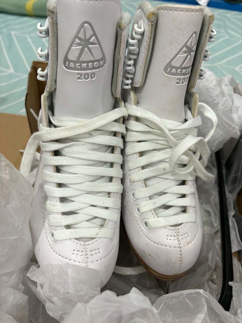 Jackson 200 Figure Skates Shoes (Category: Skates, Rollerblades & Scooters) located in Manila. Submitted by jaychiiiii (Listing ID 1470571565, Image 1). Description: - Brand/Model: Jackson 200 figure skates (White) - Included: White laces and original shoe box - Blades: Securely attached stainless steel blades with visible size mark near the heel - Condition: Minor scuffs on the toe area from past use, otherwise well-maintained.