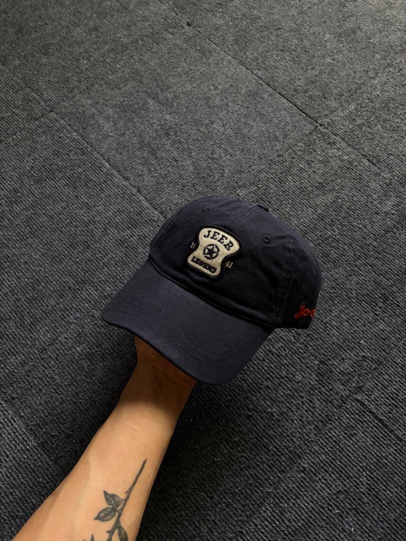 Jeep Legend Navy Blue Baseball Cap (Category: Caps & Hats) located in Manila. Submitted by toys_hats005 (Listing ID 1470628518, Image 1). Description: - Brand: Jeep Legend - Color: Navy blue - Design: Embroidered star and '1941' patch on front - Material: 100% cotton - Fit: Adjustable strap with metal buckle - Details: Contrast white brim lining, green inner tag (Made in China) - Condition: Excellent / Pre-loved - Shipping or meetups available (M