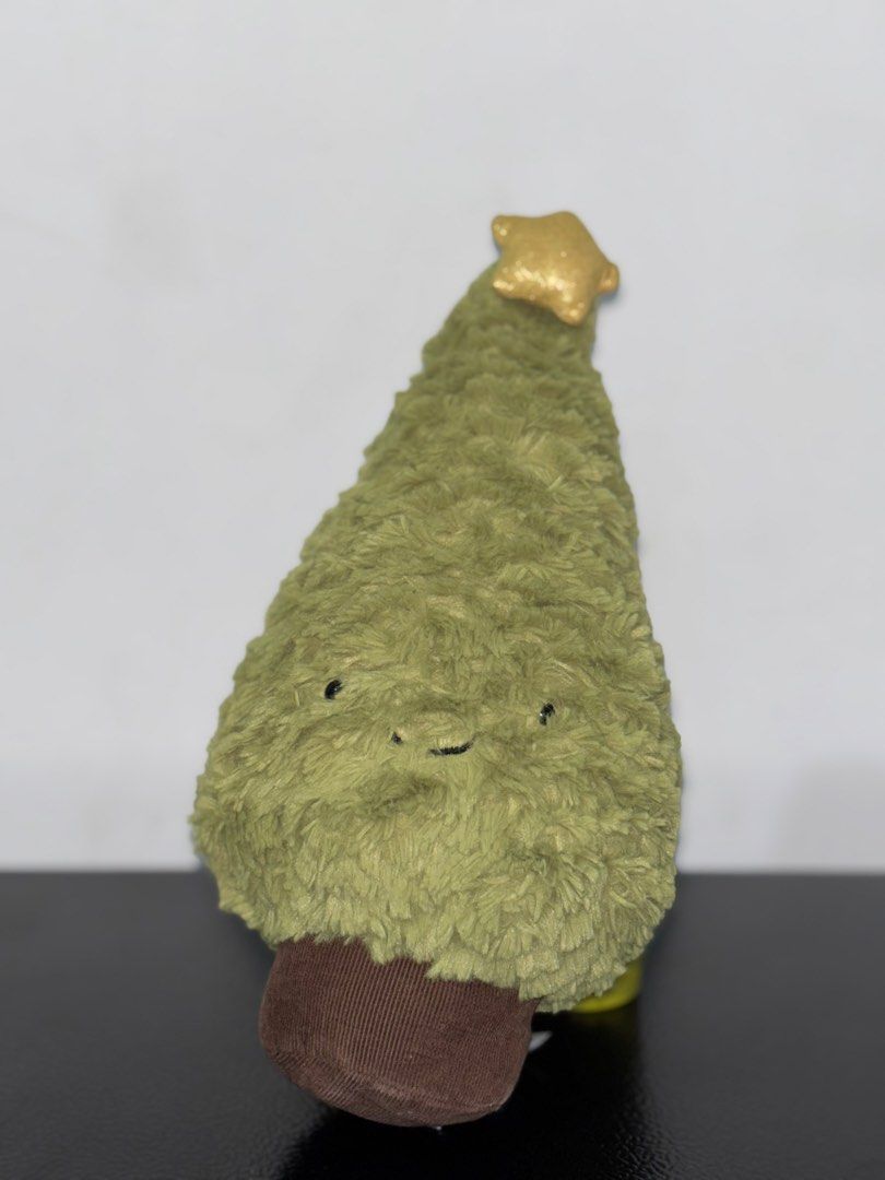 Jellycat Amuseable Christmas Tree Plush (Category: Plushies & Soft Toys) located in Cavite. Submitted by eleanordc (Listing ID 1470724796, Image 1). Description: - Authentic Jellycat Christmas tree plush toy with original brand tags attached - Soft green textured fur body with a charming brown corduroy trunk base - Topped with a festive, sparkly gold star - Features cute embroidered smile and little black bead eyes - Impeccable, clean condition i