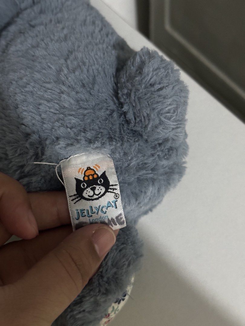 Jellycat Dusky Blue Blossom Medium (RARE) (Category: Plushies & Soft Toys) located in Cabanatuan. Submitted by tinytreasuretales (Listing ID 1470568110, Image 2). Description: - Authentic Jellycat London bunny plush in classic grey - Features a charming floral pattern on the inner ears and paws - Super soft furry texture with a sweet light pink nose - Official Jellycat tag attached on the side - Clean, well-maintained condition - Great as a cuddl